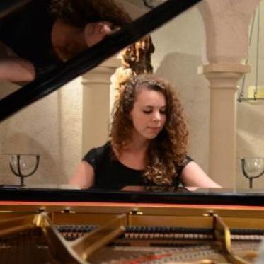 A girl playing the piano in the chapel