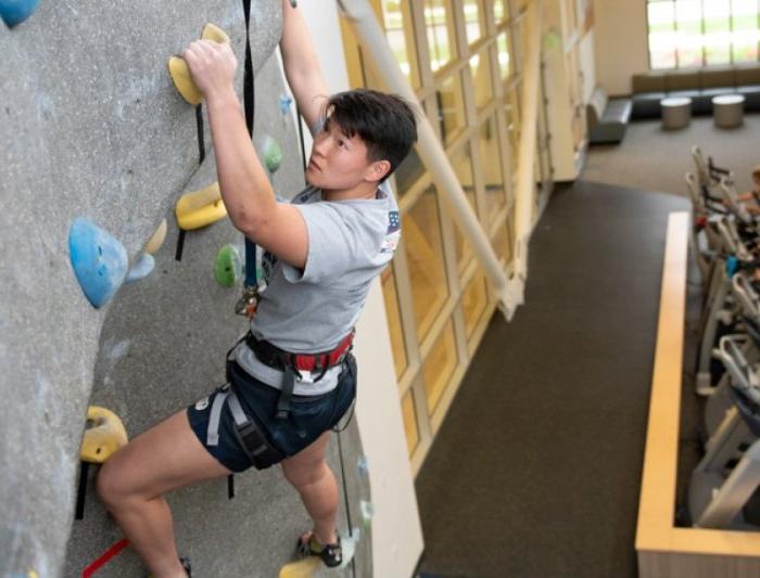 person climbing on indoor rock wall